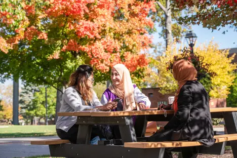 students sitting at picnic table